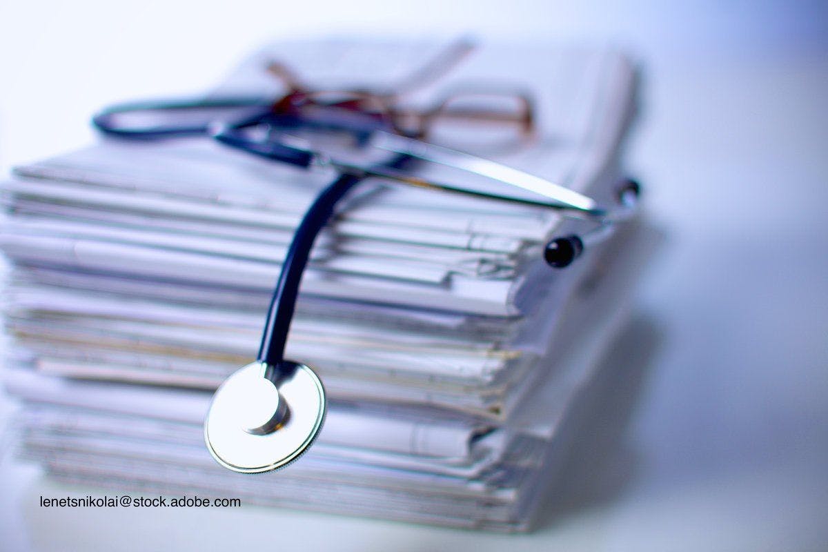 stack of studies with a stethoscope