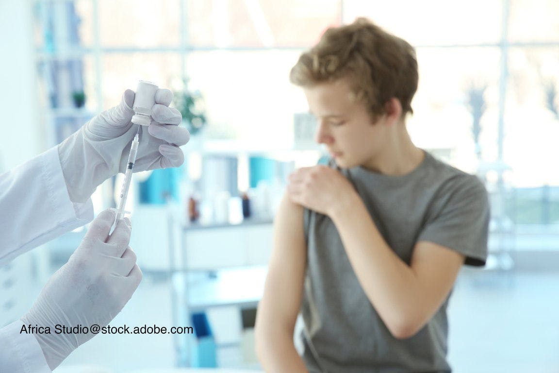 image of preteen boy getting a vaccine