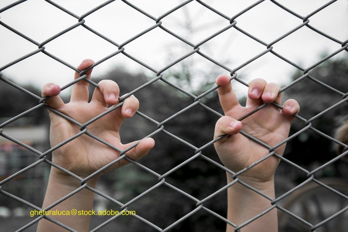 immigrant child at fence