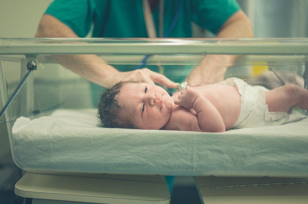 stock image of baby in a hospital nursery