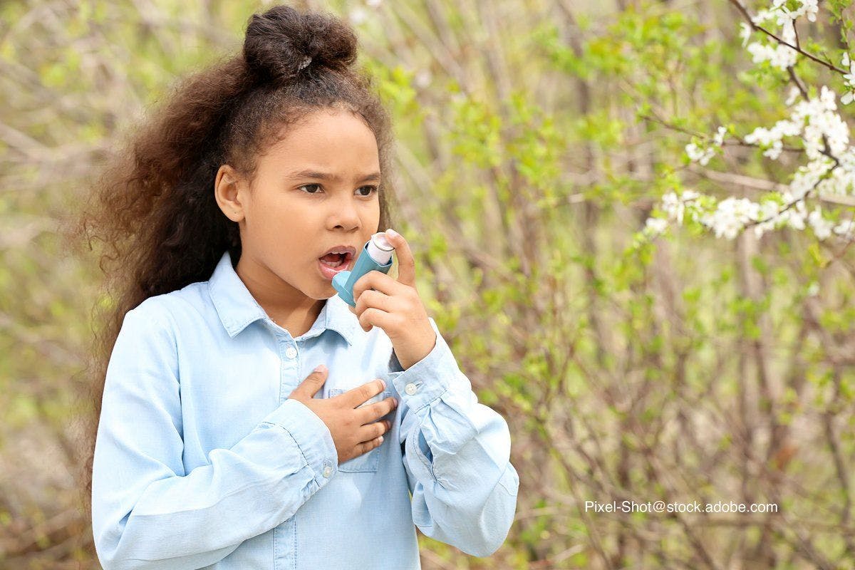 child with asthma using an inhaler