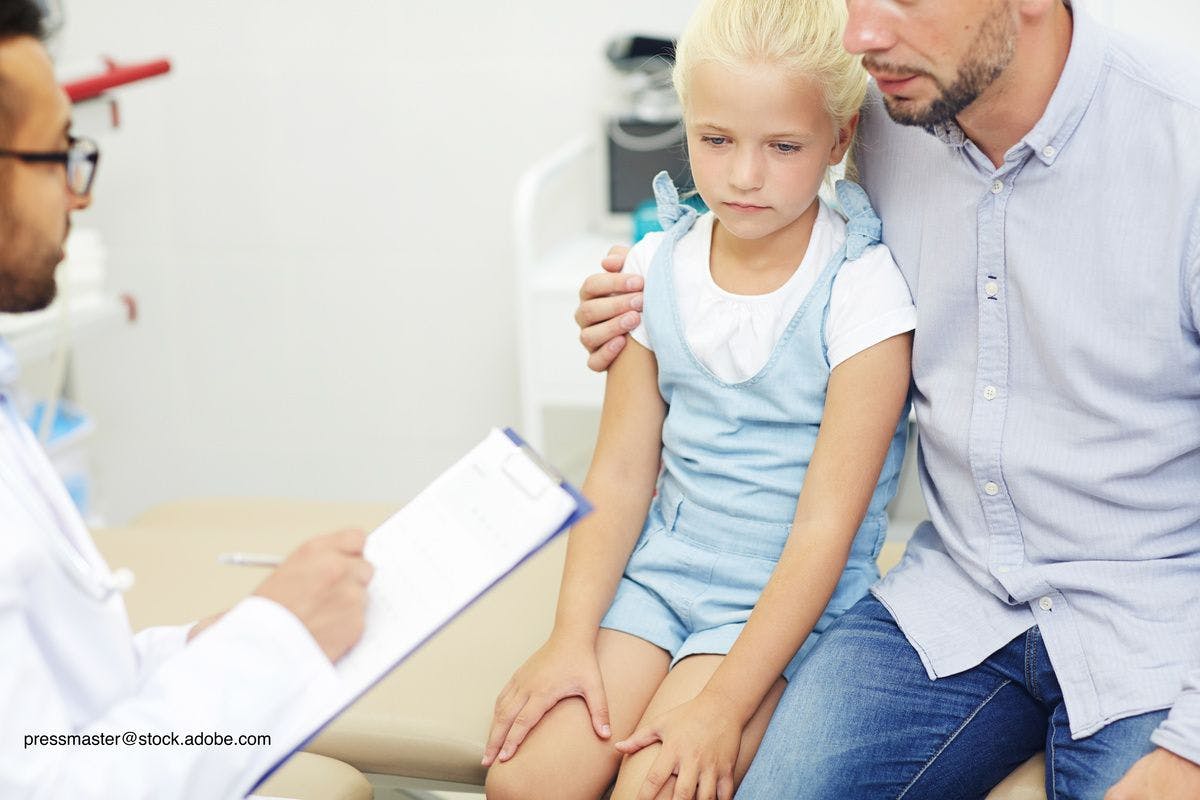 parent discussing concerns with pediatrician
