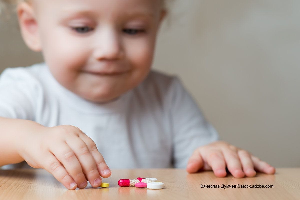 small child reaching out for pharmaceutical