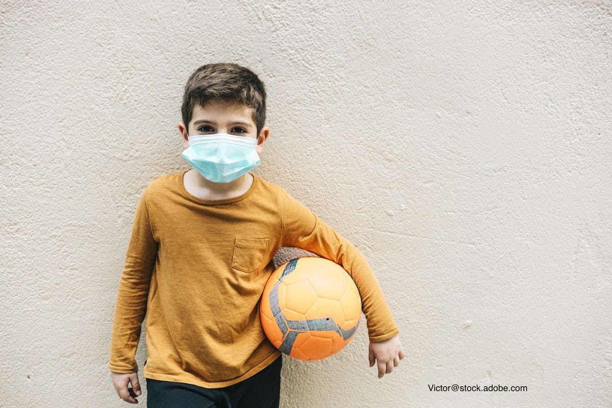 child face mask and soccer ball