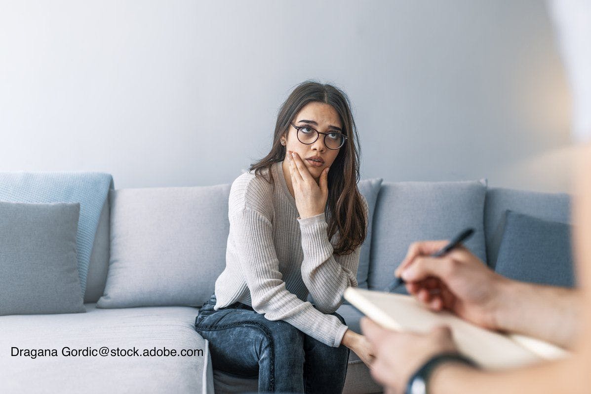 image of young woman speaking to a therapist