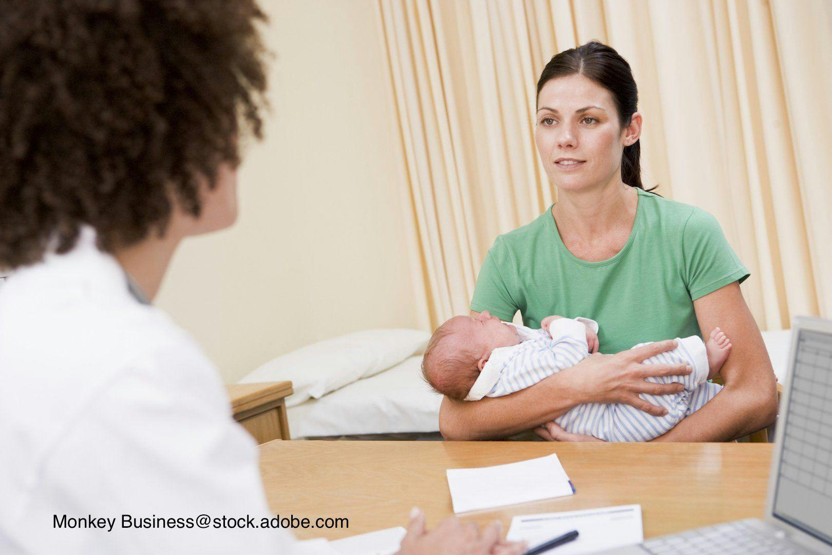 doctor counseling mother and infant