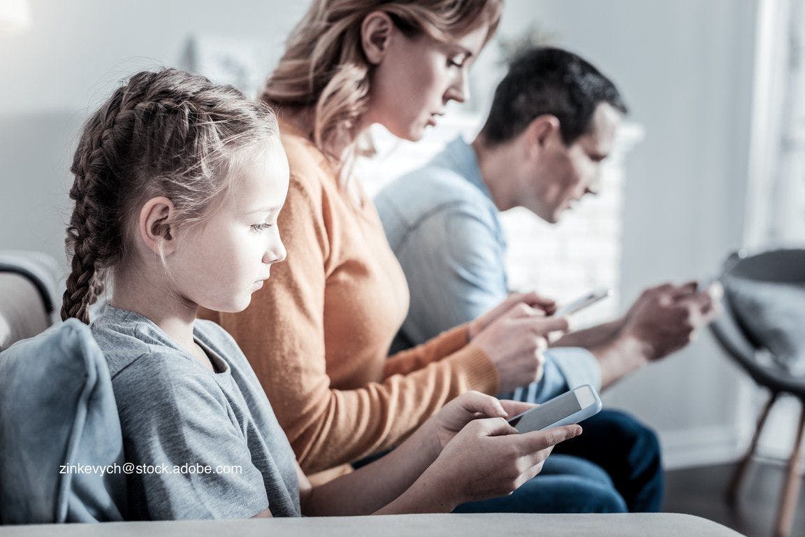 distracted family on media devices