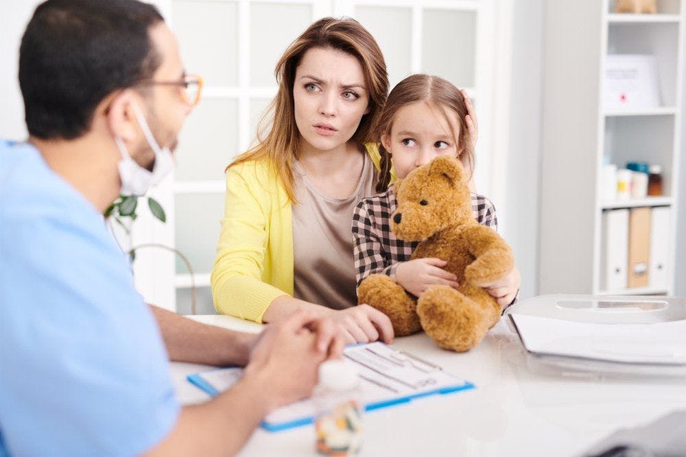 stock photo of mother talking to doctor about her child