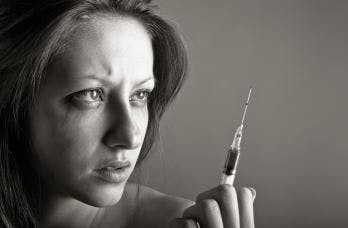 woman looking at needle